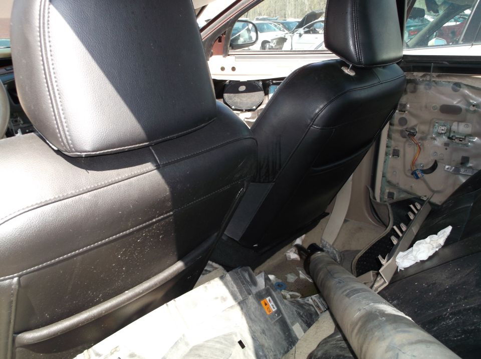 Interior view of black leather seats and door panel removed
