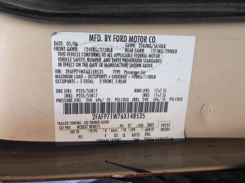 1999 Mercury Grand Marquis - A vehicle identification plate shows manufacturing details and VIN.