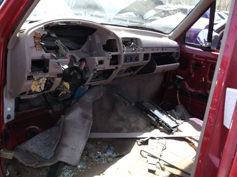 1999 Mercury Grand Marquis - Car interior disassembled, showing exposed wiring and removed dashboard components.