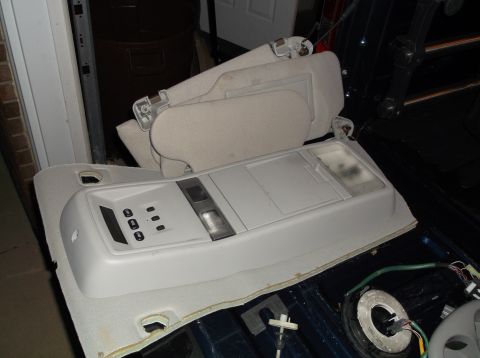 1999 Mercury Grand Marquis - Interior overhead console and sun visors are shown removed from a vehicle, likely for repair or replacement.