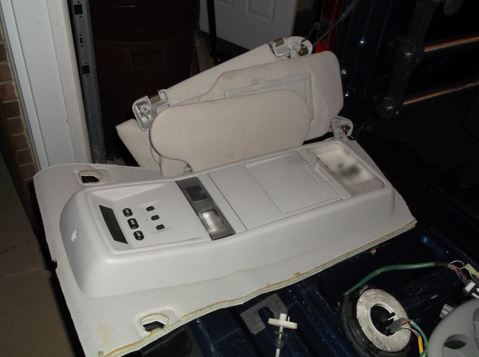 Overhead console and sun visors removed from a vehicle interior