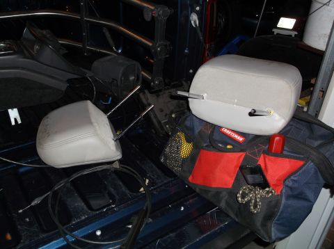 1999 Mercury Grand Marquis - Headrests and a tool bag sit in the bed of a pickup truck.