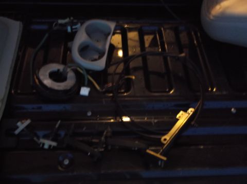 1999 Mercury Grand Marquis - Various car components and electrical wiring are visible, suggesting a repair or disassembly process.