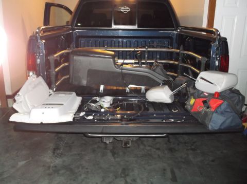 1999 Mercury Grand Marquis - Interior parts are loaded into the bed of a pickup truck.