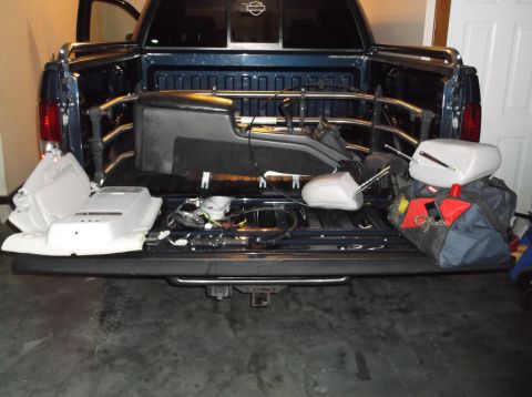 1999 Mercury Grand Marquis - Car parts are loaded into the bed of a pickup truck.
