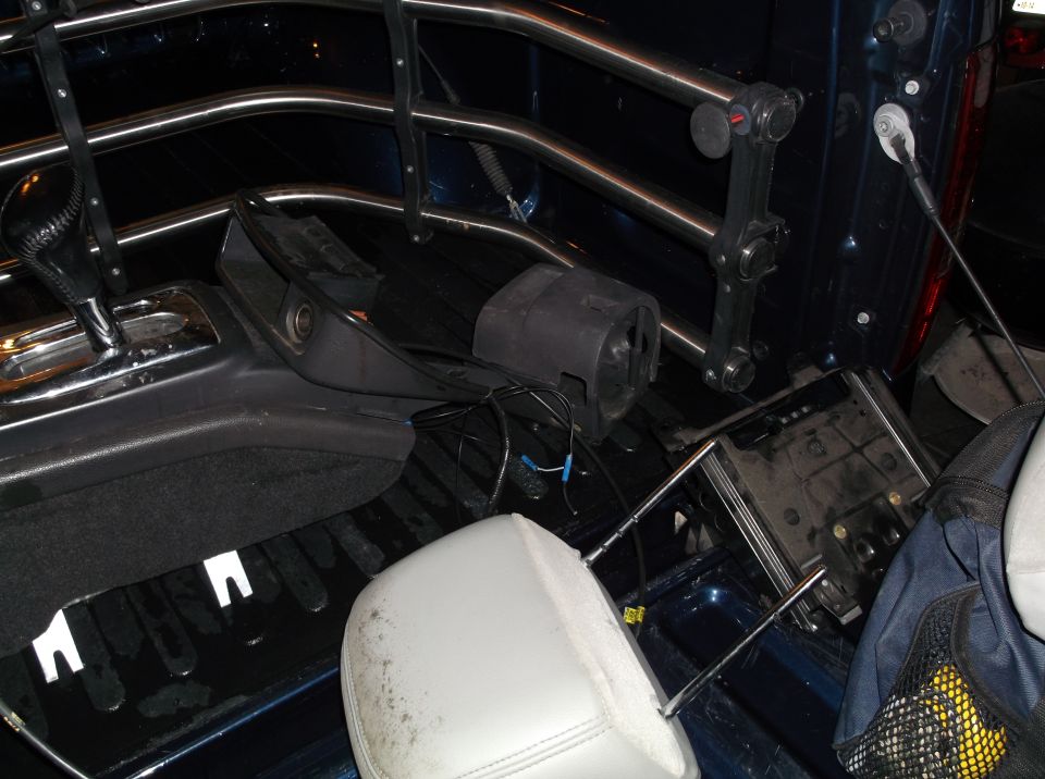 Truck bed with gear shifter, seat headrest, and other disassembled interior parts