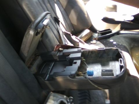 1999 Mercury Grand Marquis - Center console removed from car interior, exposing wiring and seat components.
