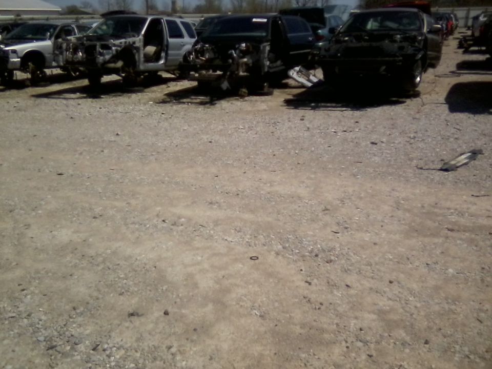 Front view of a wrecked car in a junkyard