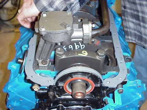 1989 Ford Bronco - Close-up of an engine component being worked on, with a gasket being fitted.