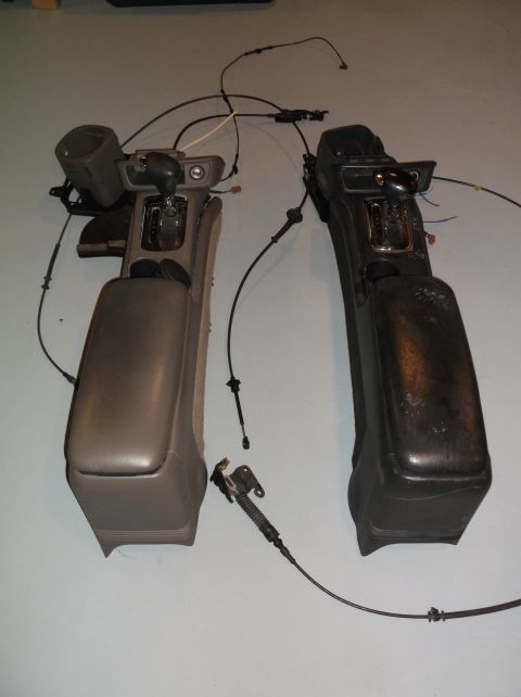 1999 Mercury Grand Marquis - Two automotive center consoles, likely for parts or repair, are displayed side-by-side against a plain background.