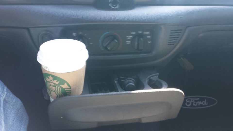 2005 Ford Crown Victoria interior showing a Starbucks cup in the center console cup holder