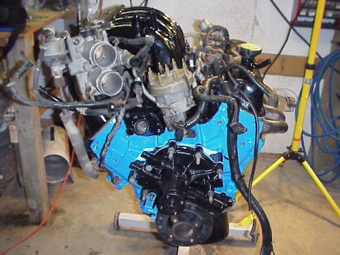 1989 Ford Bronco - Engine assembly on a stand, showing the intake manifold and distributor cap.