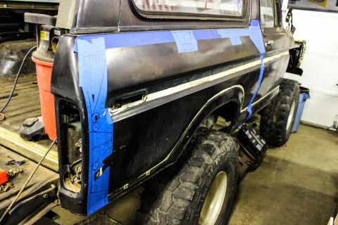 1979 Ford Bronco - Body modification in progress on a 1978 Ford Bronco, showing taped-off panel sections.
