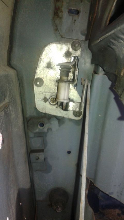 1996 Ford Bronco - Close-up view of a vehicle's door latch mechanism, showing internal components and mounting plate.