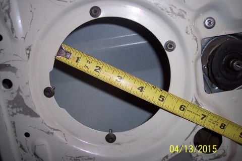 1990 Ford Bronco - Measuring the door speaker mounting hole. The tape measure shows it is about 6 inches across.