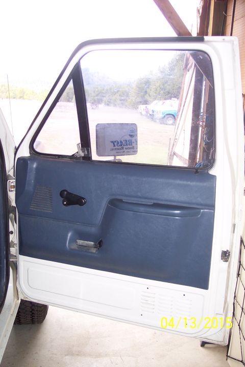 1990 Ford Bronco - Interior of a truck door, showing the blue door panel and a date stamp of 04/13/2015.