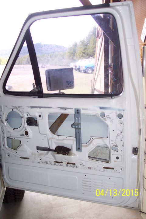 1990 Ford Bronco - Interior of a white truck door, showing the window mechanism and the date 04/13/2015 stamped on the panel.