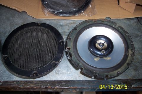 1990 Ford Bronco - A pair of car door speakers are shown, one disassembled and one with its protective grille.