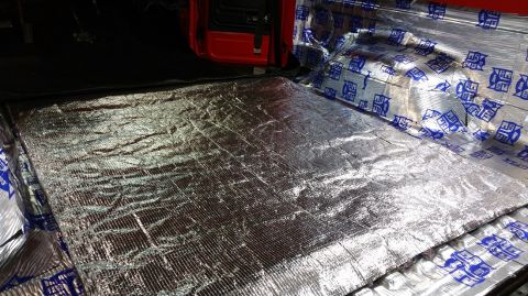 1983 Ford Bronco - Sound deadening material is installed on the floor and rear cargo area of a red vehicle.