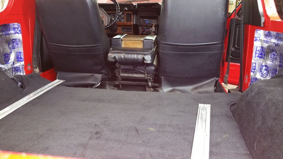 Interior of red SUV showing black seats, carpeted floor, and center console