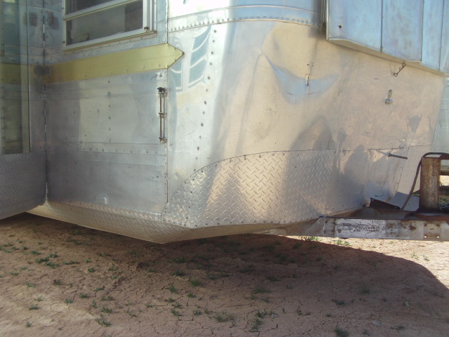 aluminum trailer side with diamond plate lower section and a door latch
