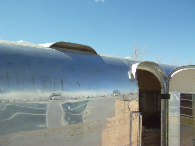 Aluminum trailer side with open door and roof vent