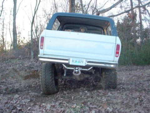 1979 Ford Bronco - This 1978 Ford Bronco is shown from the rear, with its license plate visible, on a dirt path.