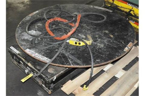 1969 Ford Torino - A round black object with tangled wires and a red loop sits atop a black box, likely part of industrial equipment.