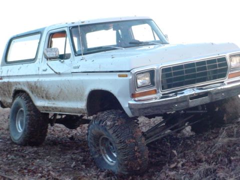 1979 Ford Bronco - This lifted 1979 Ford Bronco is shown off-road, covered in mud.
