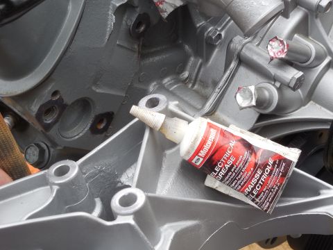 1993 Ford Bronco - Since the alternator's output is dependent on a solid ground path through the engine block to the battery (-) post, I removed the paint (DE…
