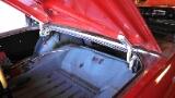 1964 Ford Fairlane - The interior of a car's trunk is shown with the lid open.