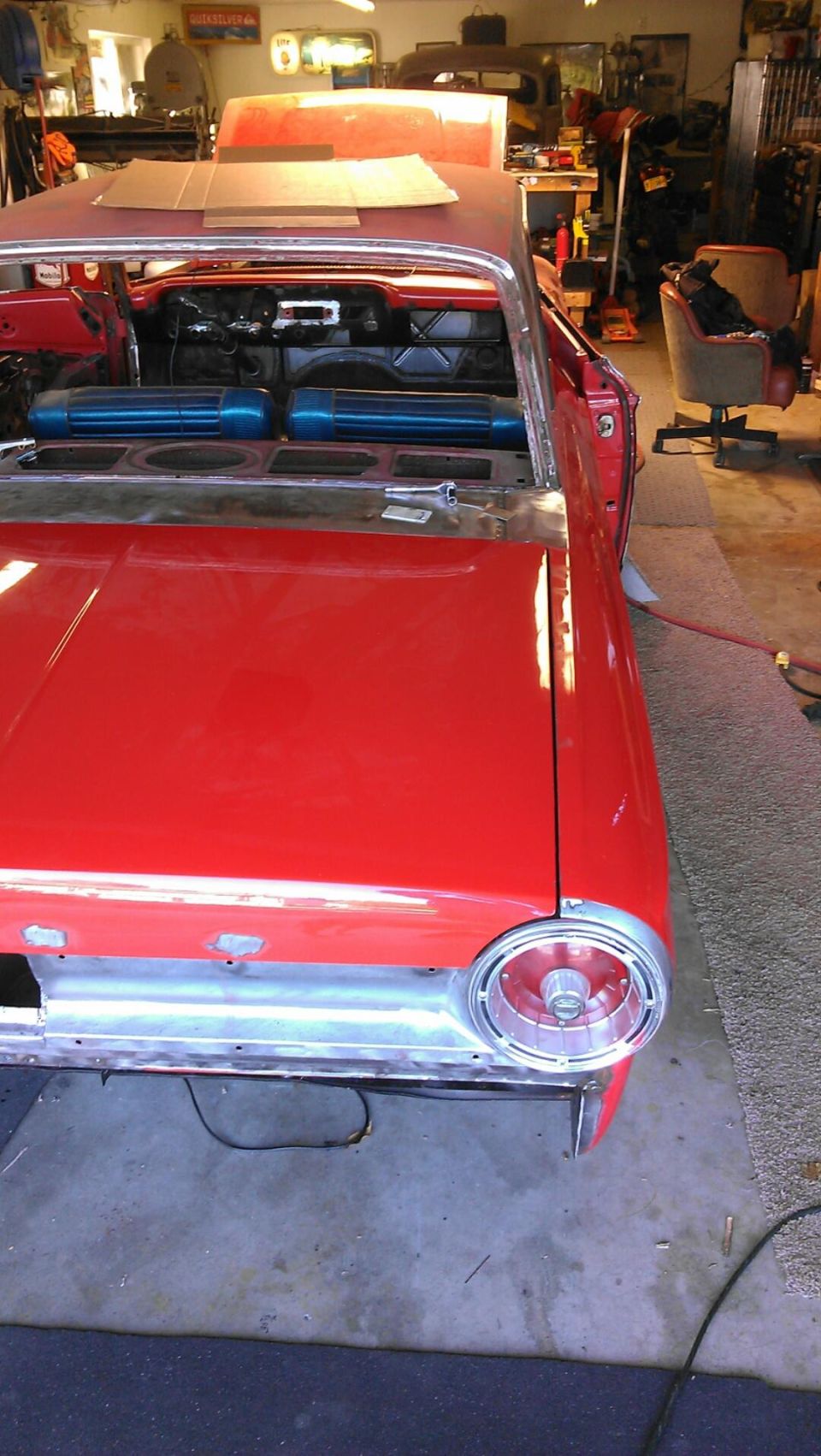 Red 1964 Ford Fairlane interior with blue seats and exposed metalwork