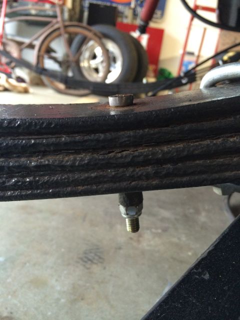 1964 Ford Fairlane - Close-up view of a vehicle's leaf spring assembly, with a bolt and nut visible.