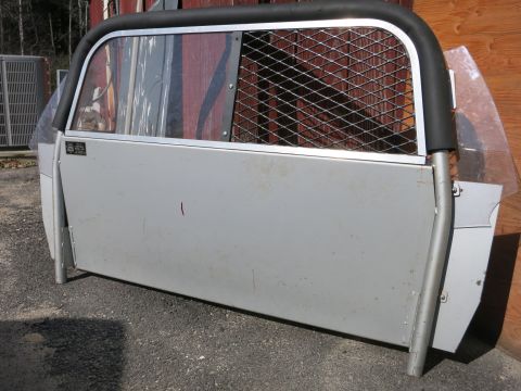 1991 Ford LTD Crown Victoria - This is a partition, likely for a vehicle, with protective mesh and plastic.