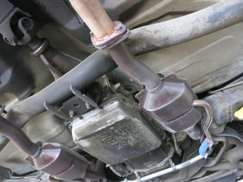 1991 Ford LTD Crown Victoria - Underside view of a vehicle's exhaust system and transmission components.