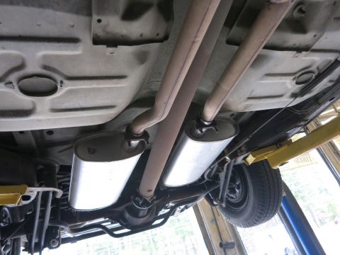 1991 Ford LTD Crown Victoria - Underside view of a vehicle's exhaust system, showing dual mufflers and pipes.