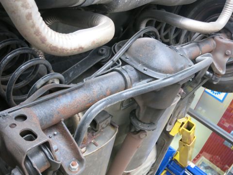 1991 Ford LTD Crown Victoria - Close-up view of the undercarriage, showing the differential and suspension system of a vehicle.