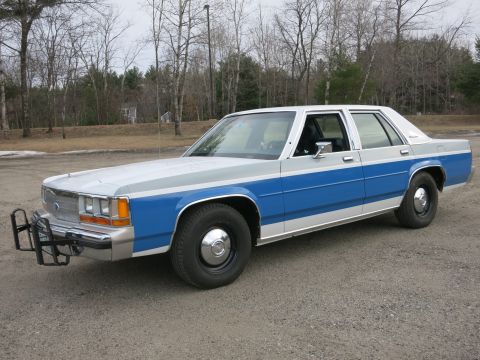 1991 Ford LTD Crown Victoria - This 1991 Ford Crown Victoria LTD features a distinctive two-tone blue and silver paint scheme and a front push bar.