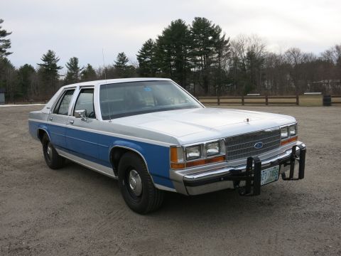 1991 Ford LTD Crown Victoria - This 1991 Ford Crown Victoria LTD features a distinctive two-tone blue and silver paint scheme and a robust push bar.