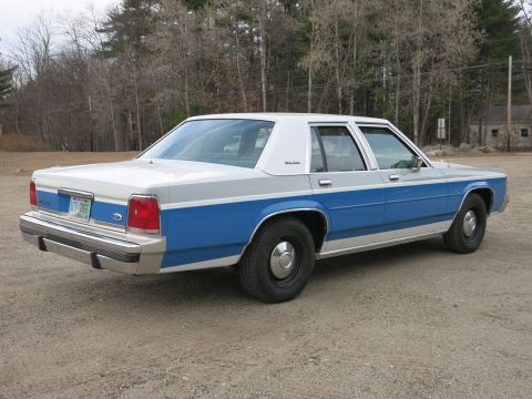 1991 Ford LTD Crown Victoria - This 1991 Ford Crown Victoria LTD sedan is seen from a three-quarter front angle on a dirt lot.