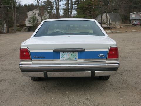1991 Ford LTD Crown Victoria - Rear view of a 1991 Ford Crown Victoria LTD, showing its distinctive taillights and chrome bumper.
