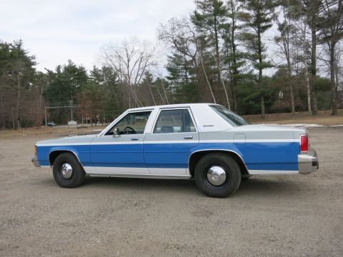 1991 Ford LTD Crown Victoria - This sedan has a distinctive two-tone paint scheme with blue lower panels and gray upper panels.