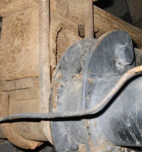 1996 Ford Bronco - This image shows a close-up view of the rear axle and suspension components of a vehicle, with visible rust and wear.