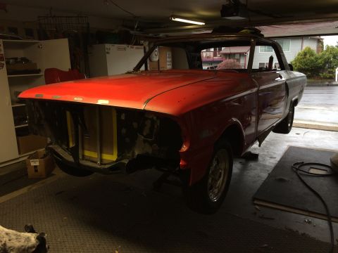 1964 Ford Fairlane - A red 1964 Ford Fairlane is seen in a garage, appearing to be in the process of restoration.