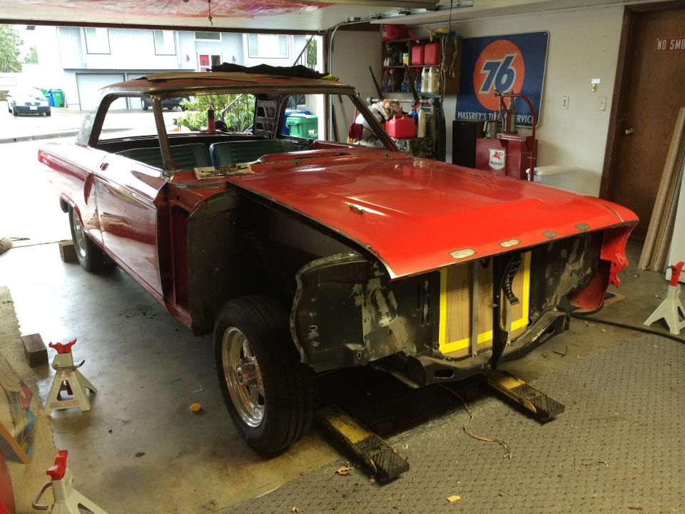 Red 1964 Ford Fairlane in garage, undergoing restoration