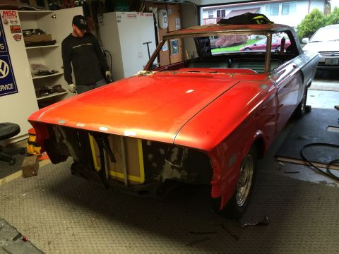 1964 Ford Fairlane - A red 1964 Ford Fairlane convertible is shown in a garage, appearing to be in the process of restoration with its front end disassembled.