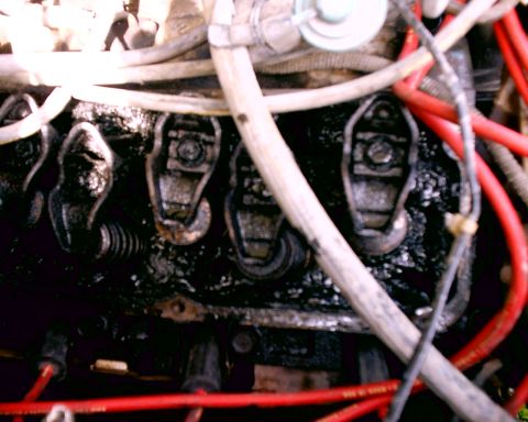 1980 Ford Bronco - The image shows a close-up view of an engine's valve train components, covered in grime and oil.