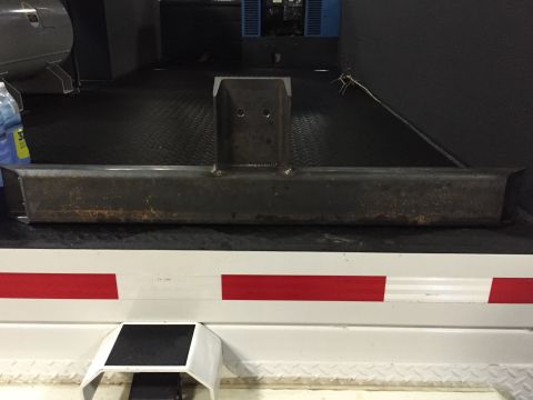 1994 Ford Bronco - A metal trailer hitch is shown attached to the rear of a white trailer with red reflective tape.