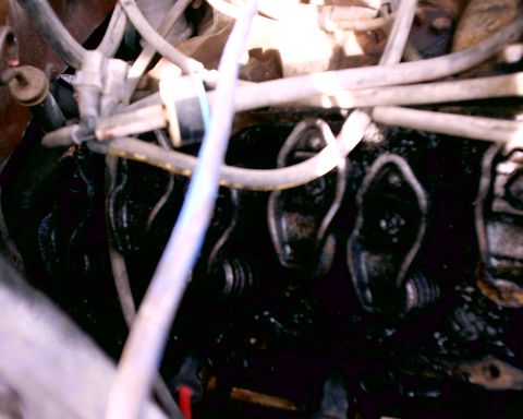 1980 Ford Bronco - Close-up view of an engine's internal components, showing valve train parts and associated hoses.