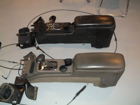 1999 Mercury Grand Marquis - Two disassembled car center consoles are laid out on the floor, showing different color options.